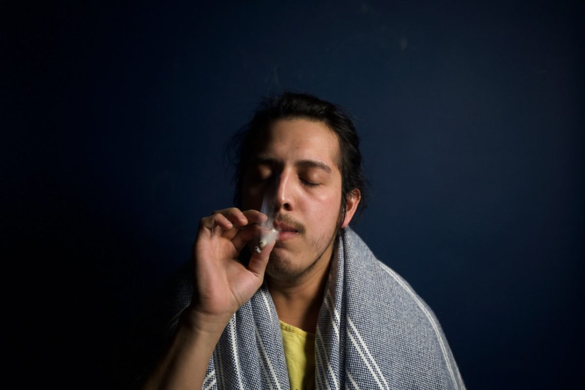 man taking a hit of a joint