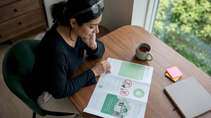 Woman reading cannabis age restriction brochure
