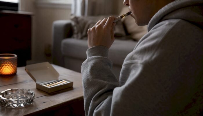 Hands priming cannabis vape cartridge